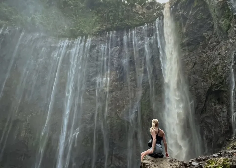 Tourist Enjoying The Breathtaking Scenery Of Tumpak Sewu Waterfall In East Java Tourist Enjoying The Breathtaking Scenery Of Tumpak Sewu Waterfall In East Java